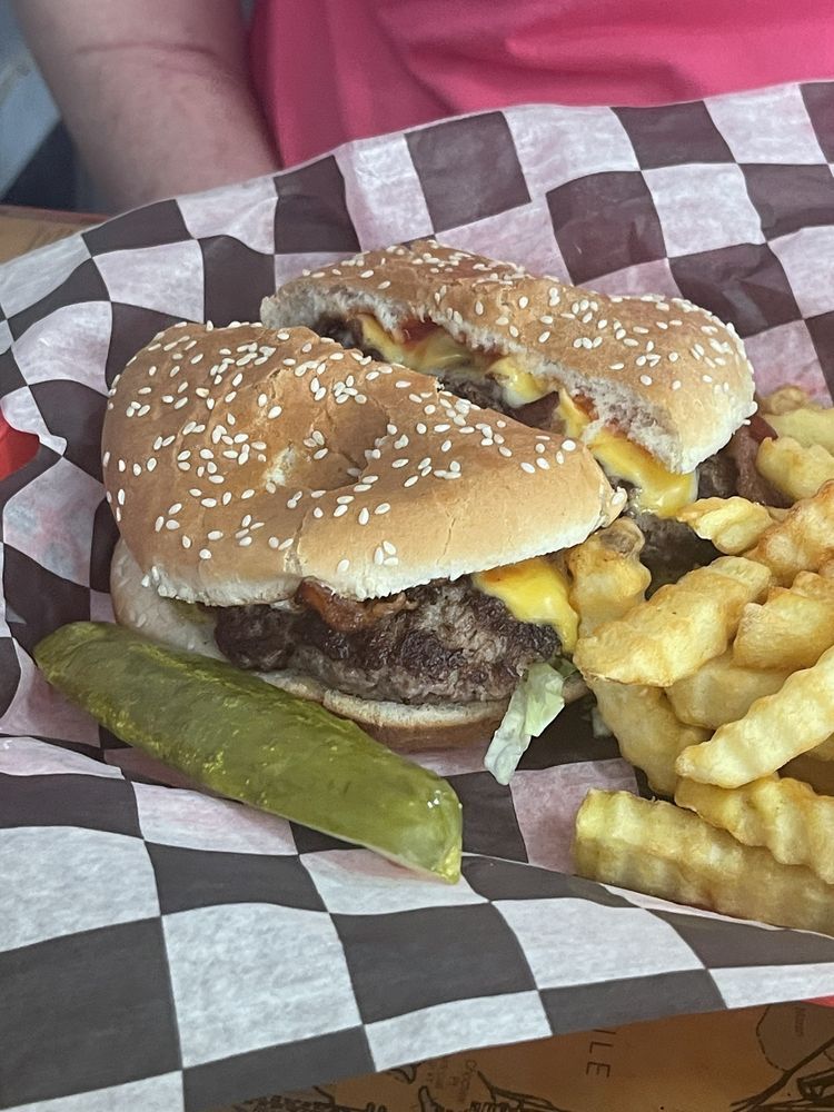 Bacon Cheese Steer burger with crinkle-cut fries and a pickle spear