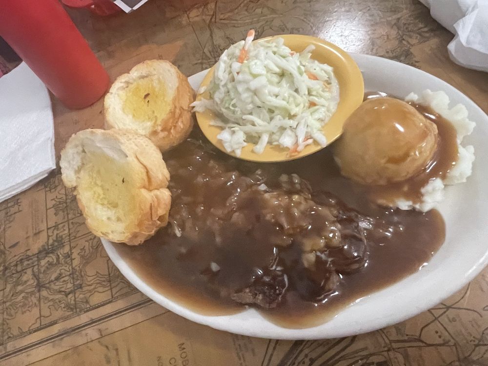 Chopped steak plate lunch with gravy, mashed potatoes, coleslaw and toasted bread
